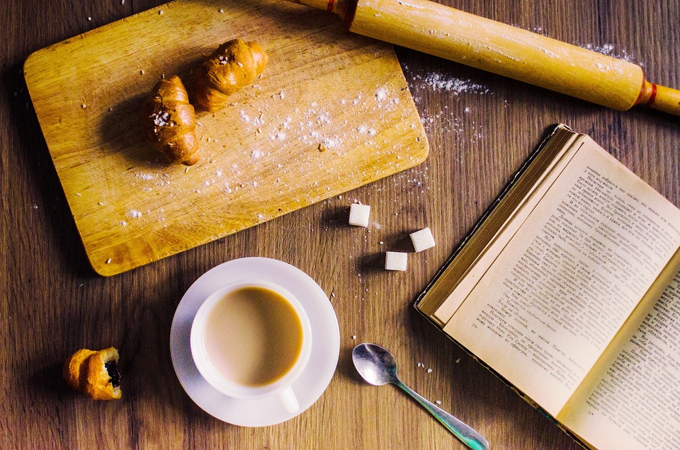 plan de travail avec croissants, café et livre